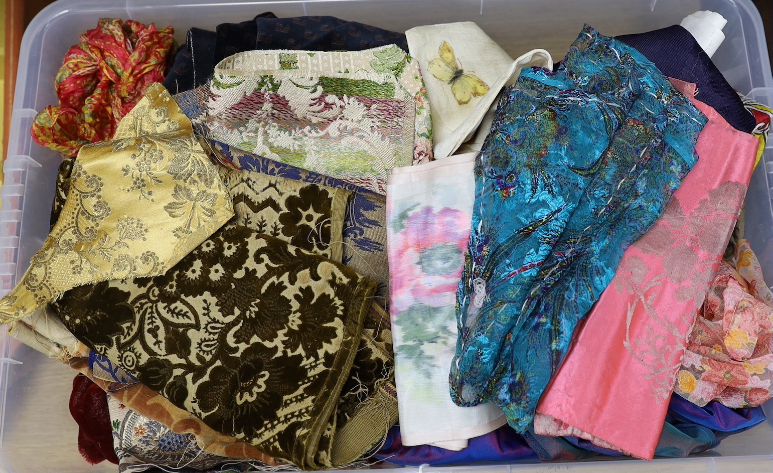 A collection of fabrics, silks, velvets and a shot silk taffeta skirt, ribbons and 19th century samples cut velvets